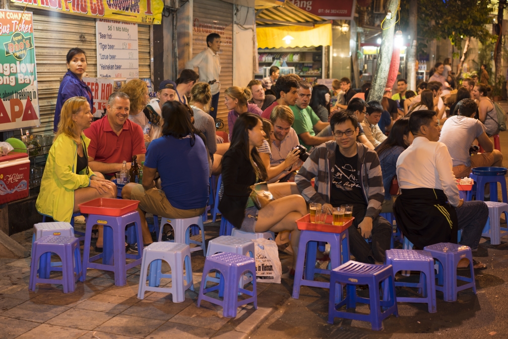 People drink beer on street at night in old quarter, center of Hanoi.