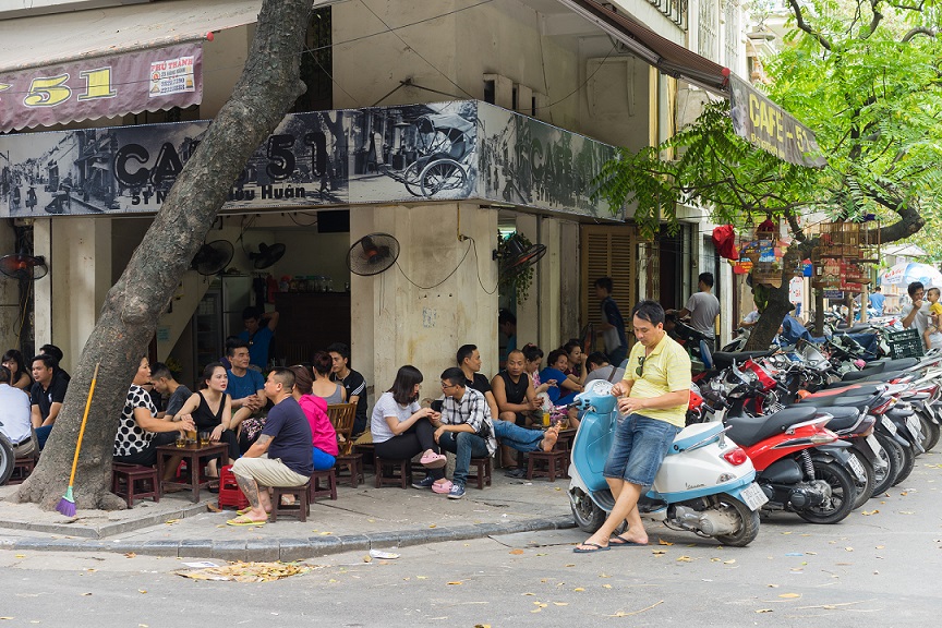 People enjoy coffee, tea on a street cafe in Nguyen Huu Huan street, Hanoi