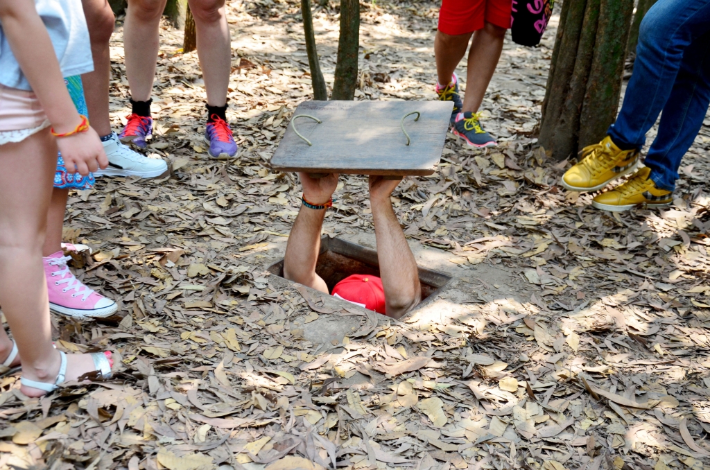 A tourist trying to enter a tunnel at Cu Chi tunnels in Ho Chi Minh city, Vietnam