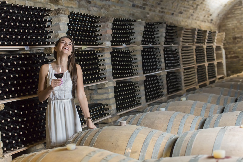Young woman in the wine cellar