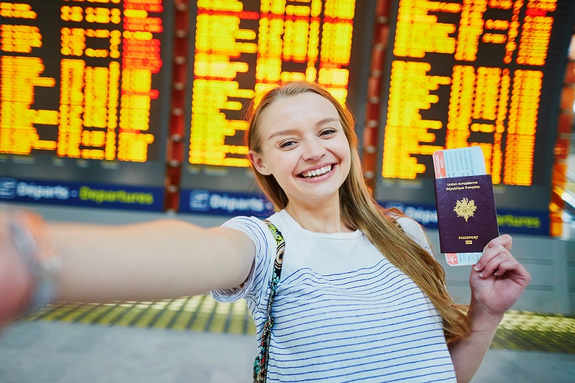 A tourist holding French passport at the international airport