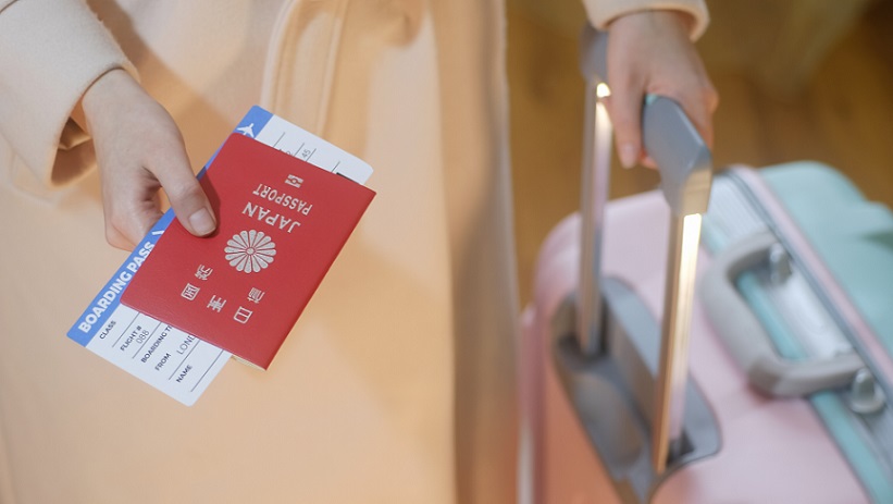 A tourist holds Japan passport and boarding pass