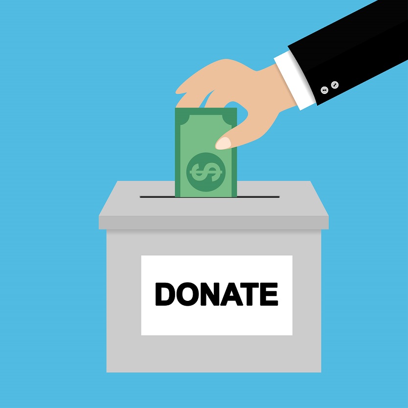 Hand putting money in donation box