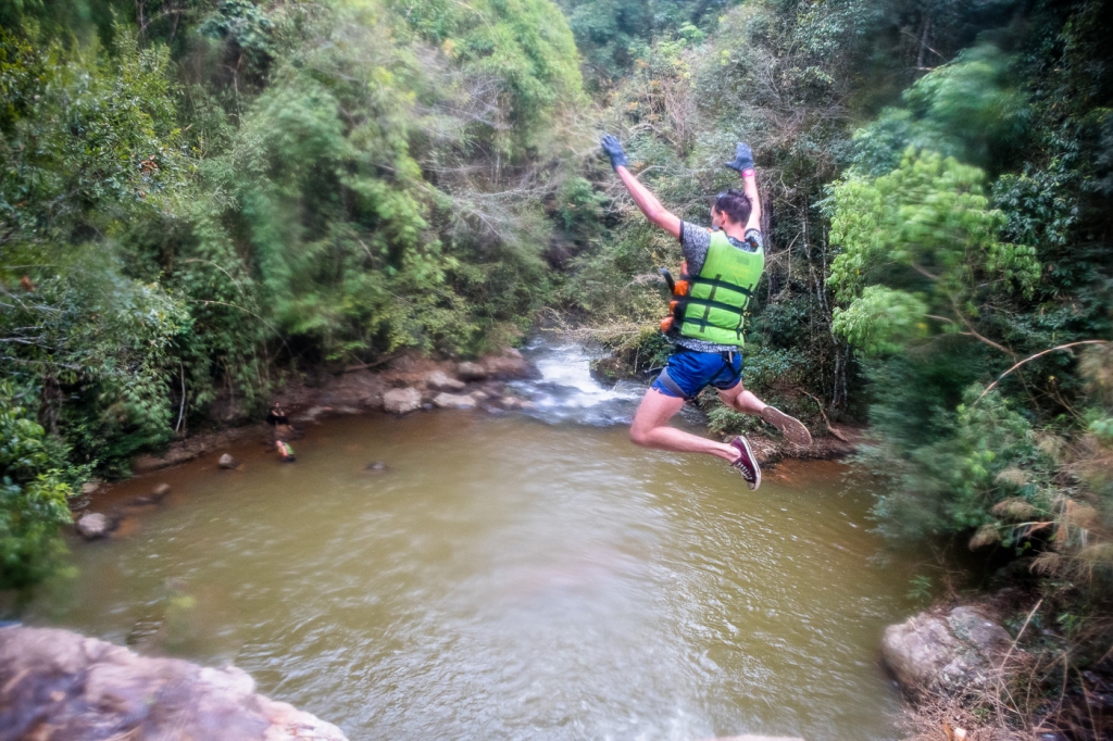 Cliff jumping during while canyoning Dalat Vietnam