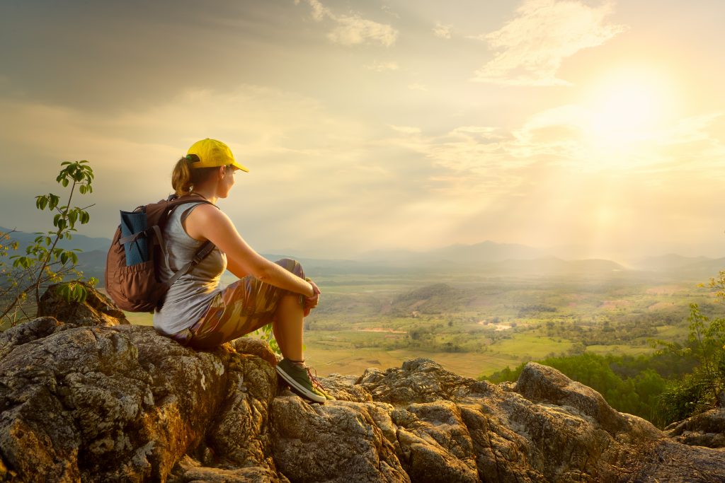 A tourist enjoying sunset and valley view.