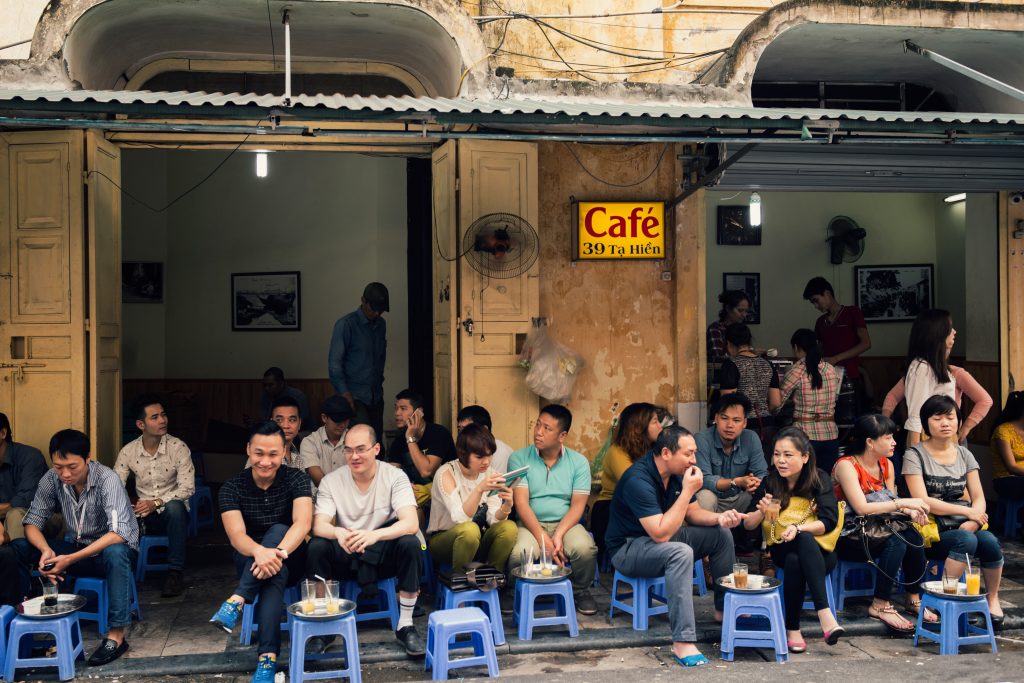 People drink coffee in side walk in Hanoi Old Quarter